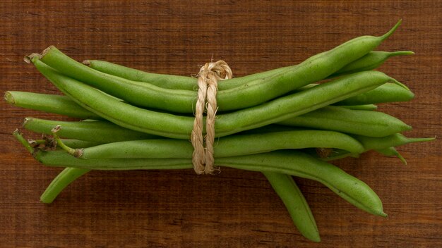 Flat lay pea pods on table tied with rope