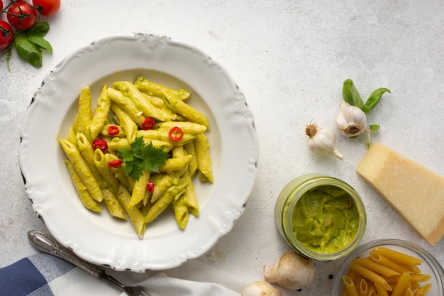 Flat lay penne with pesto and red peppers