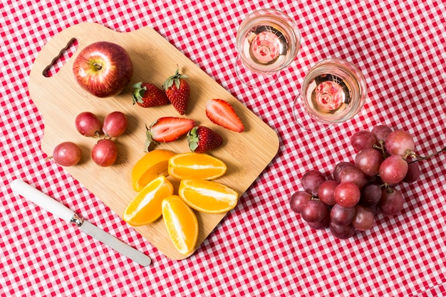 Flat lay picnic with fruits and glasses of wine