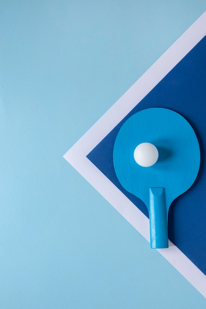 Flat lay of ping pong ball and paddle