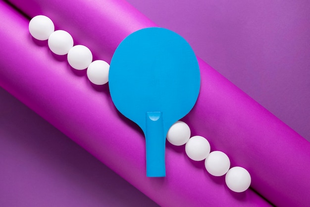 Flat lay of ping pong balls and paddle