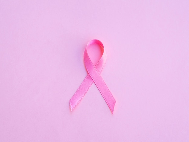 Free Photo flat lay pink ribbon and background