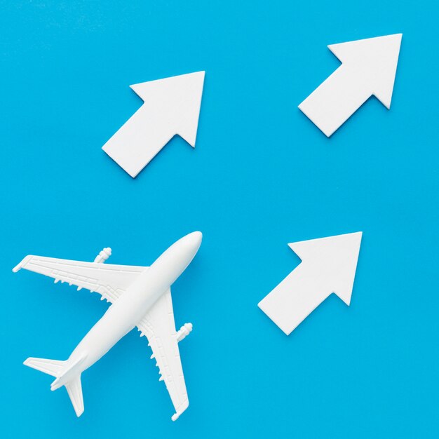 Flat lay of plane following white arrows