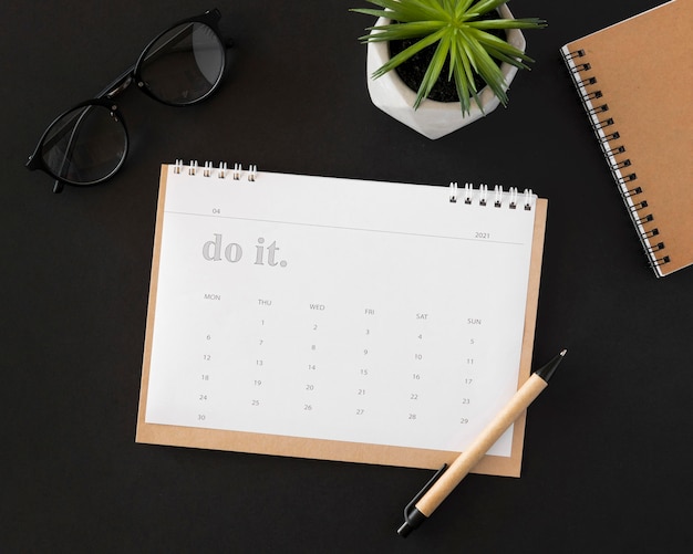 Flat lay planner calendar on dark background