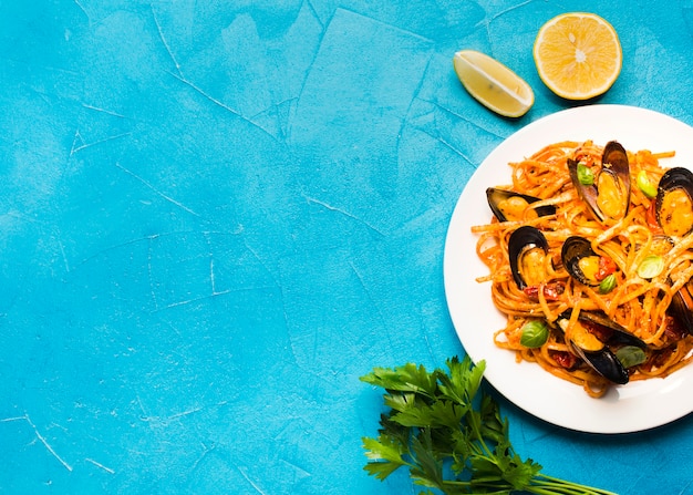 Flat-lay plate of mussels pasta with copyspace