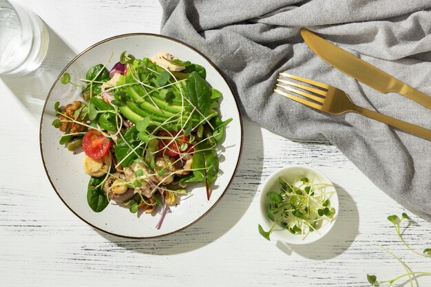 Flat lay of plate with keto diet food and golden fork and knife