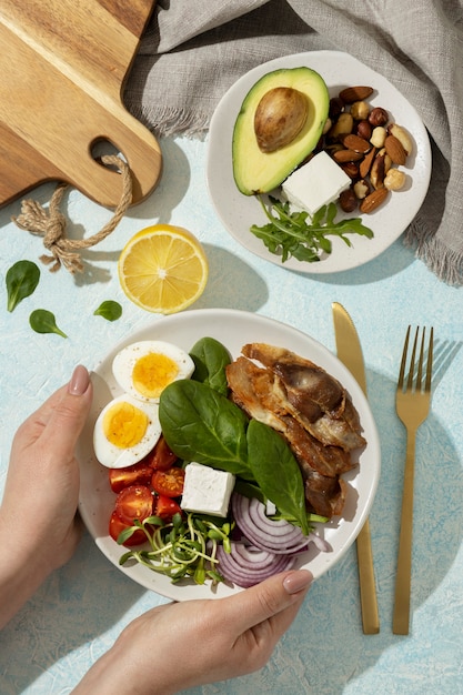 Flat lay of plate with keto diet food and nuts