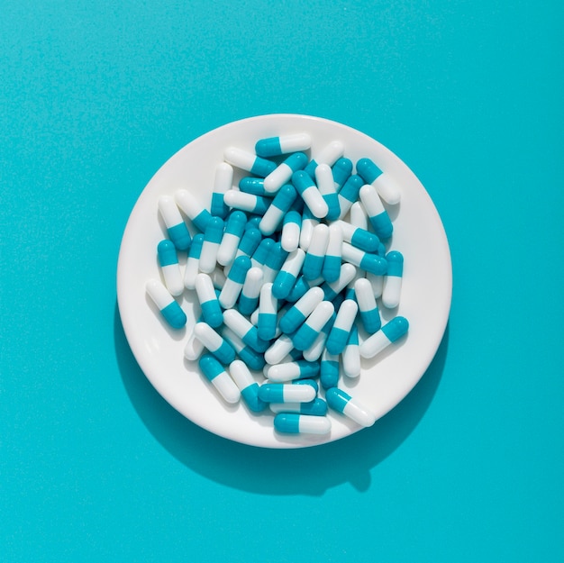 Free photo flat lay of plate with multiple pills