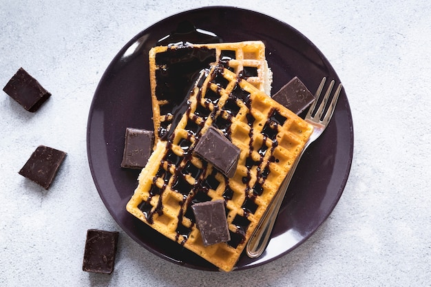 Flat lay of plate with waffles and chocolate