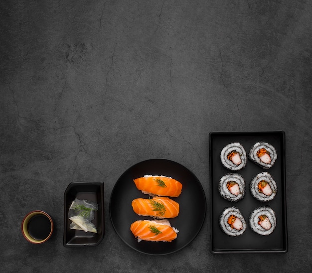 Flat lay plates with maki and nigiri sushi with copy space