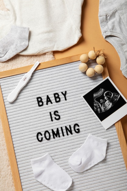 Flat lay pregnancy announcement with baby items