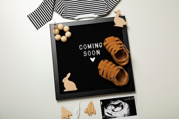 Free photo flat lay pregnancy announcement with baby items