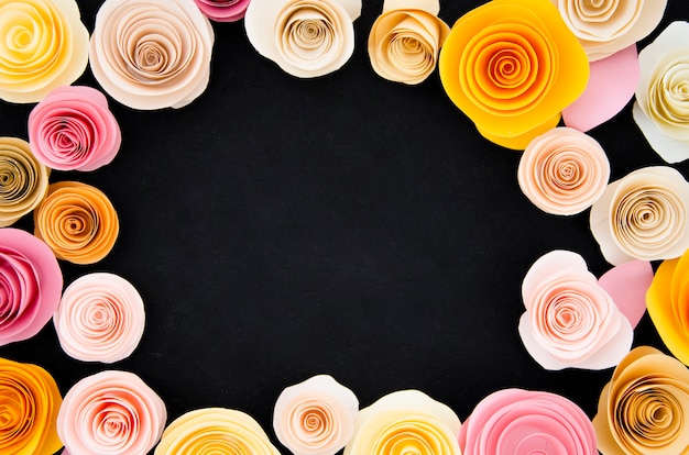 Free photo flat lay pretty floral frame on black background