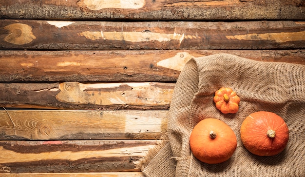 Flat lay pumpkin on canvas bag and wooden background