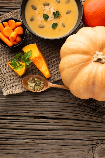 Flat lay pumpkin soup carrots and pumpkin with copy space