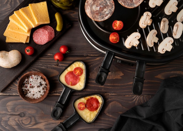 Free photo flat lay of raclette dish with delicious food assortment