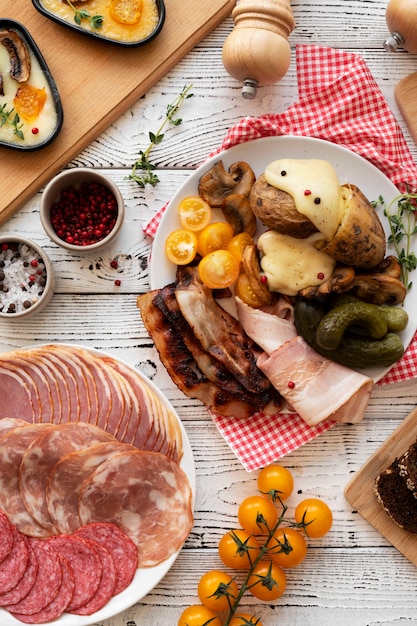 Flat lay of raclette dish with delicious food assortment