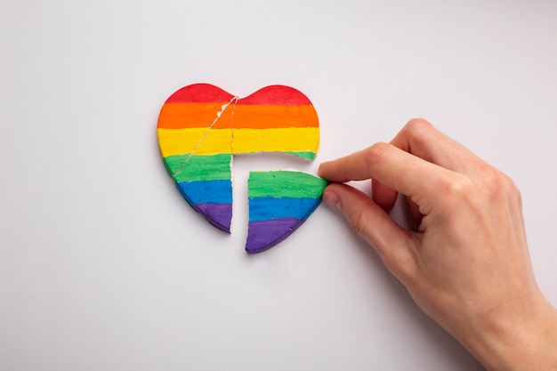 Flat lay rainbow broken heart on white background