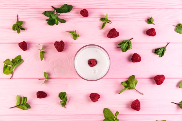 Free photo flat lay raspberry milkshake on a pink wooden table