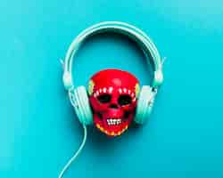 Free photo flat lay red skull with headphones