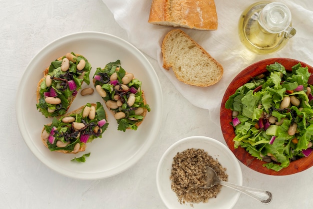 Free Photo flat lay salad with white beans on bread