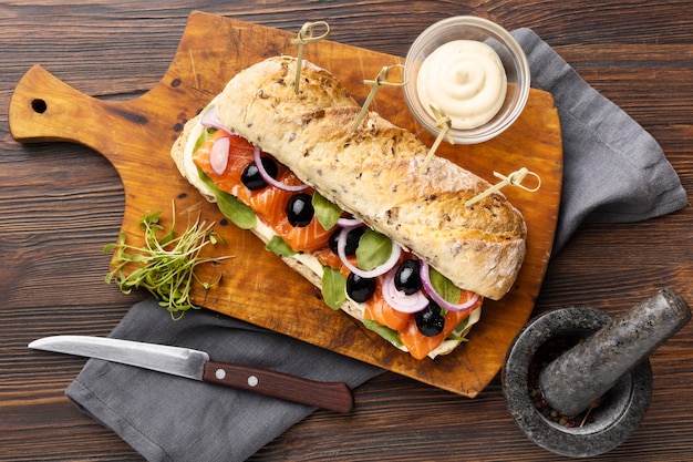 Flat lay of salmon sandwich with cutlery