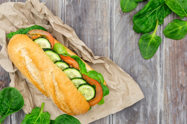 Flat lay of sandwich with spinach and cucumber slices