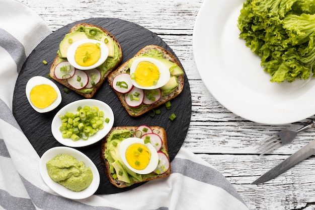 Free Photo flat lay of sandwiches with egg and avocado on slate