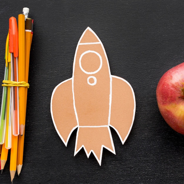 Free photo flat lay of school essentials with apple and pencils