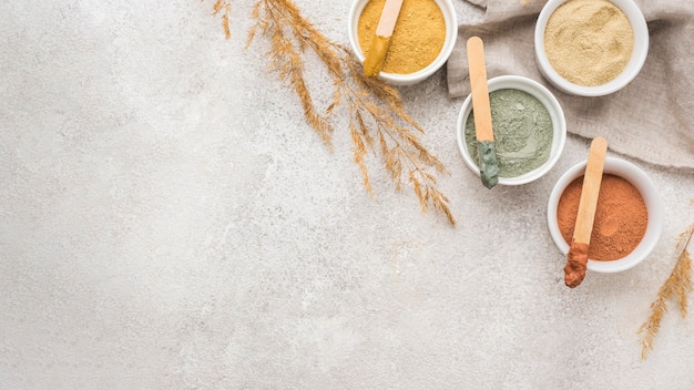 Flat lay of selection of bowls with powder and copy space