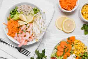 Free photo flat lay of shrimp and vegetables on plates