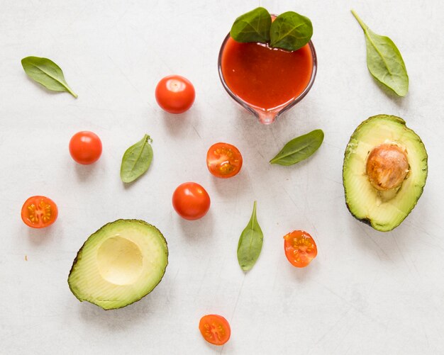 Flat lay sliced avocado with tomatoes