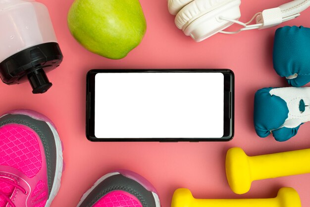 Flat lay of smartphone with sport essentials