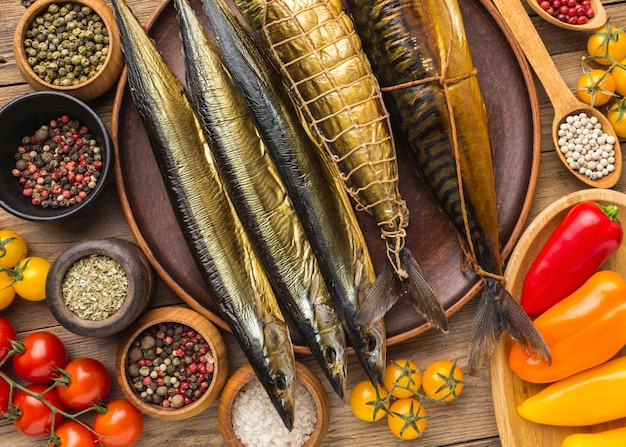 Free photo flat lay smoked fishes on wooden table