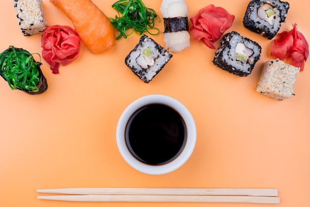 Flat lay soya souce and sushi rolls