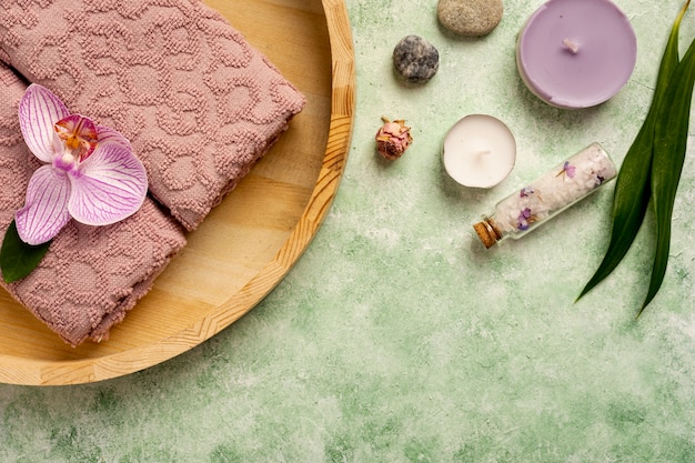 Flat lay spa decoration with towels and candles