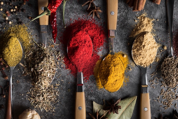 Flat lay spoons with different spices