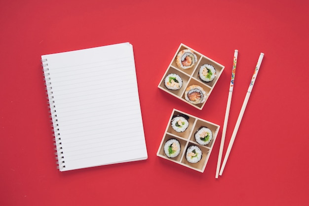 Free photo flat lay sushi composition with notepad template