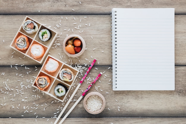 Free photo flat lay sushi composition with notepad template