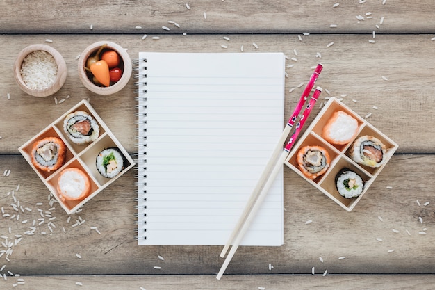 Free photo flat lay sushi composition with notepad template