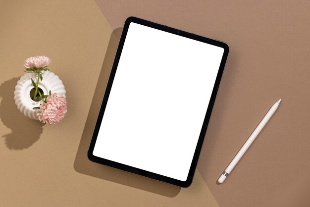 Flat lay tablet and flowers arrangement