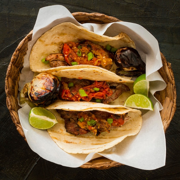 Flat lay tacos with meat in basket