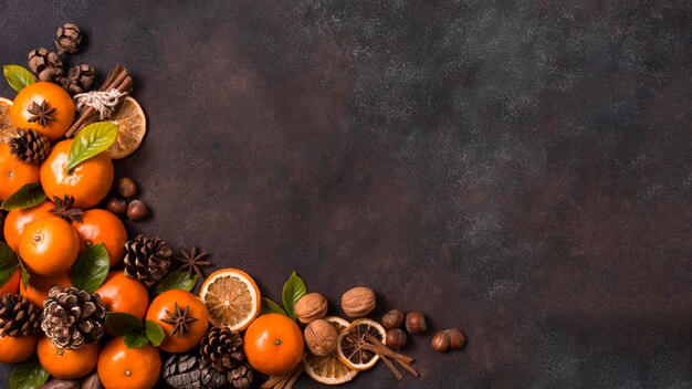 Flat lay of tangerines with pine cones and walnuts for christmas