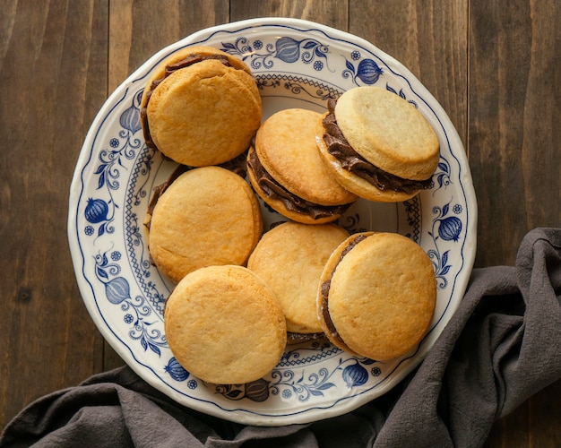 Flat lay tasty biscuits with cream