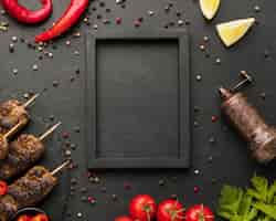 Free photo flat lay of tasty kebab with condiments and frame