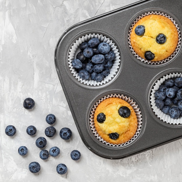 Free photo flat lay tasty muffin with blueberry forest fruit