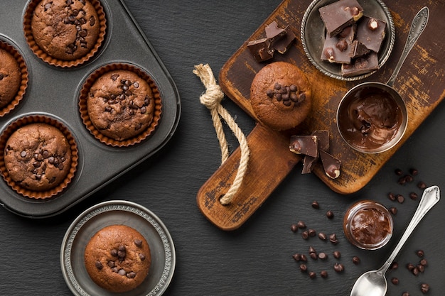 Flat lay tasty muffin with chocolate and chocolate chips