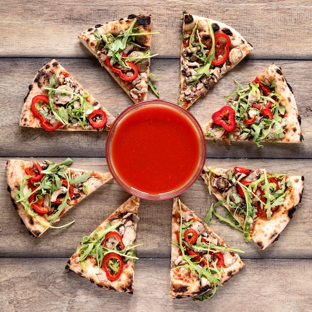 Free photo flat lay tasty pizza on wooden background