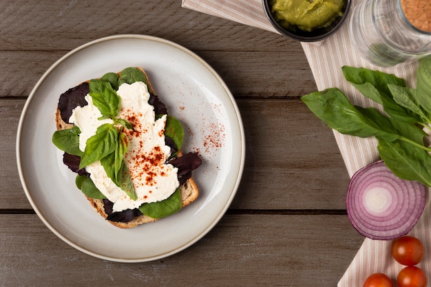 Flat lay tasty sandwich on wooden table