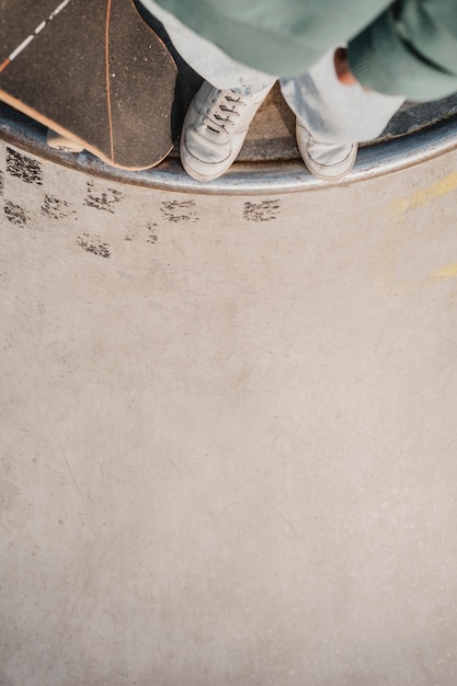 Flat lay of teenager with skateboard